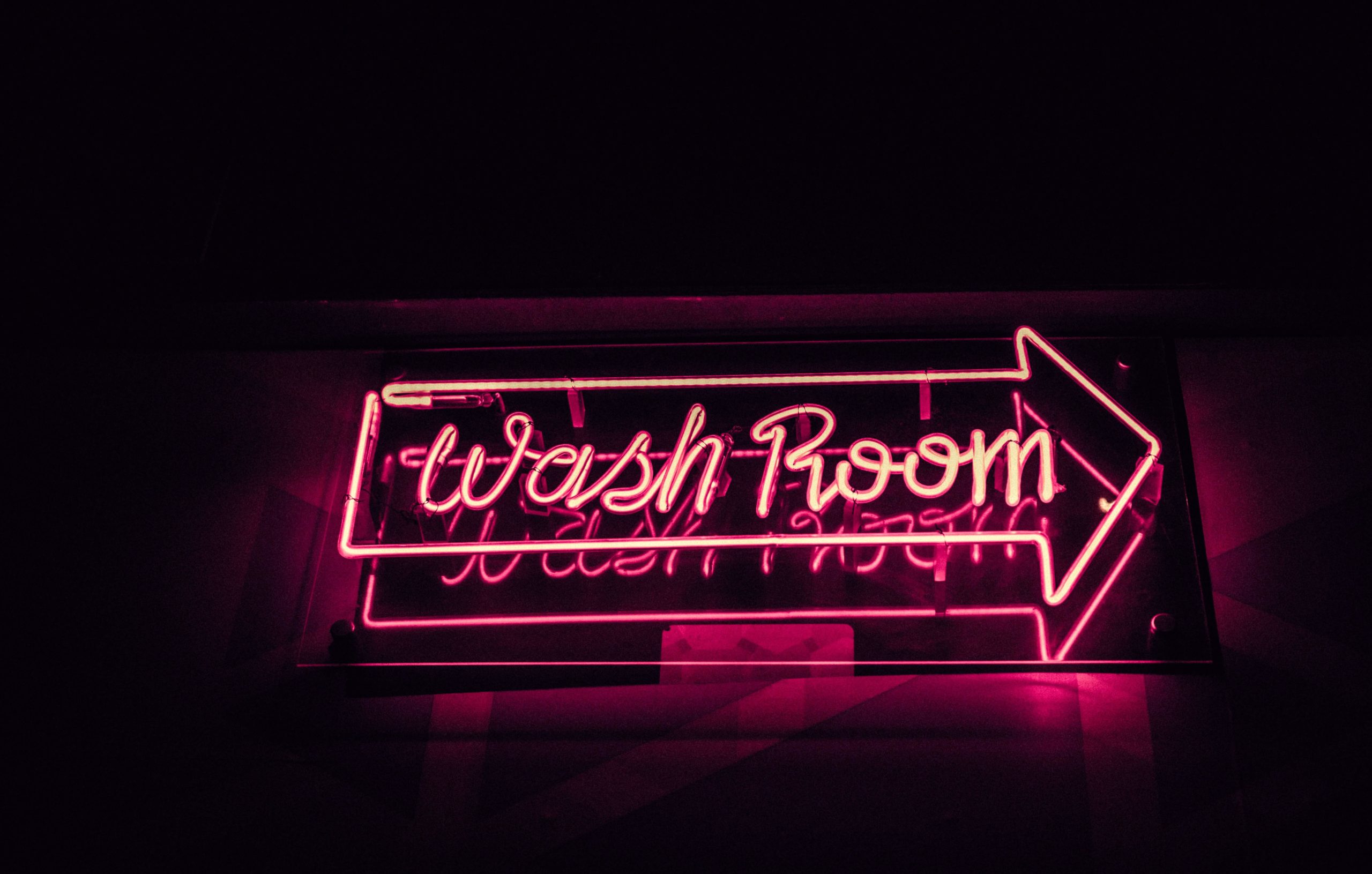 neon pink washroom sign